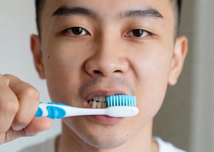 a man brushing in a wrong way