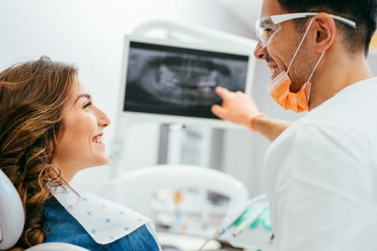 dentist explaining Smile Makeover Cost